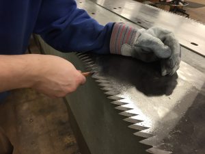 Saw blade being worked on
